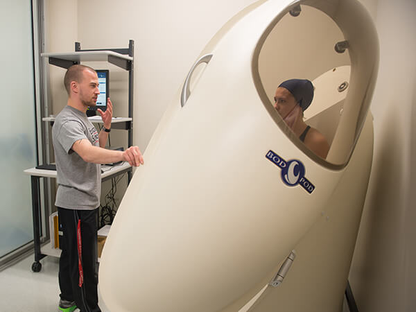 Students using the Bod Pod on the Physiology Lab.