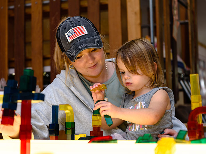Adult and preschooler playing with blocks.
