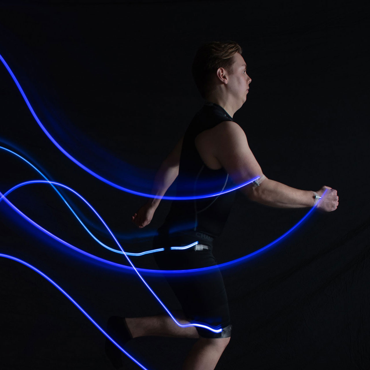 Woman with light sensors on her arm and wrist to measure movement.
