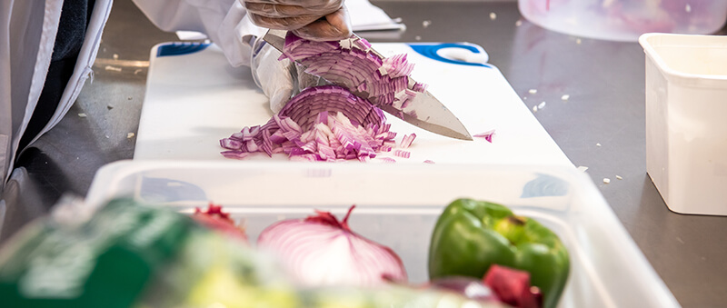 A chef chopping onions.